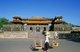 Vietnam: A woman delivers furniture for an outdoor foodstall in front of the Ngo Mon Gate (Cửa Ngọ Môn), The Imperial City, The Citadel, Hue